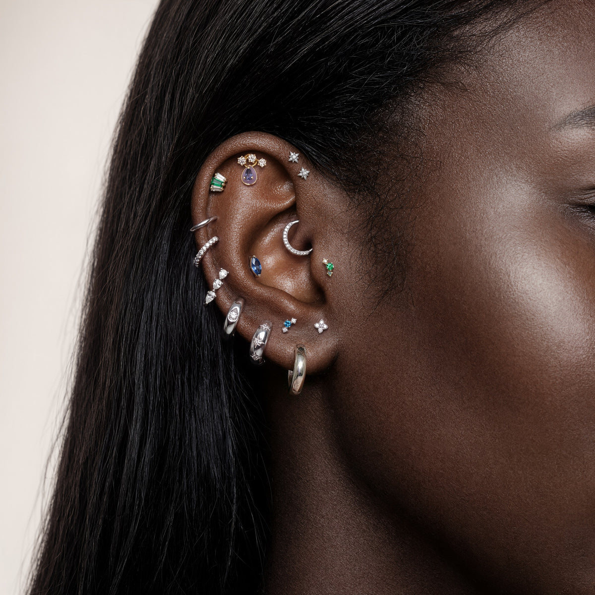 This image shows an earscape featuring the golden titanium marquise flatback with a blue cz stone. 