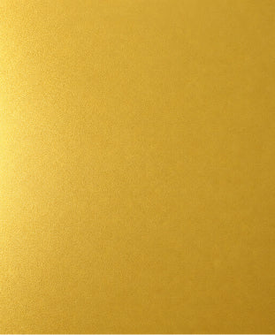 A close-up of a textured gold surface.