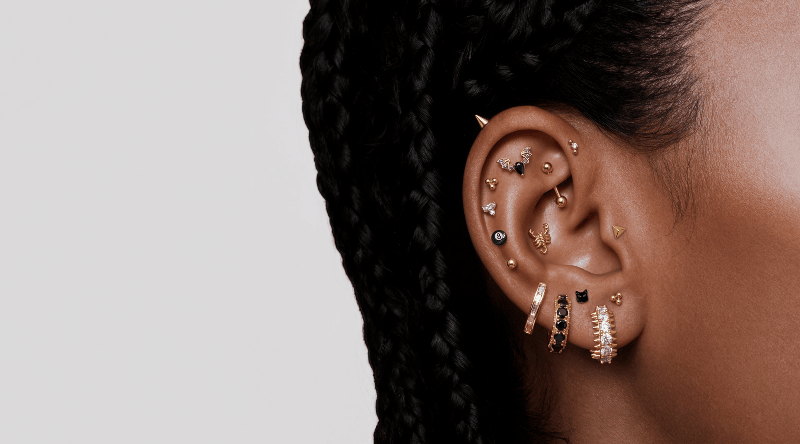 On ear photos featuring the new Halloween Collection of black pave, scorpions, 8 balls, and black cats - Spooky Season is Here! 