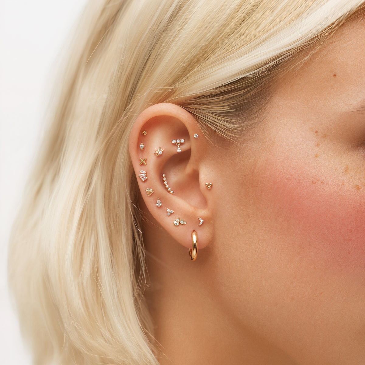 Gold earscape featuring 14k yellow gold micro flatbacks up the ear. 