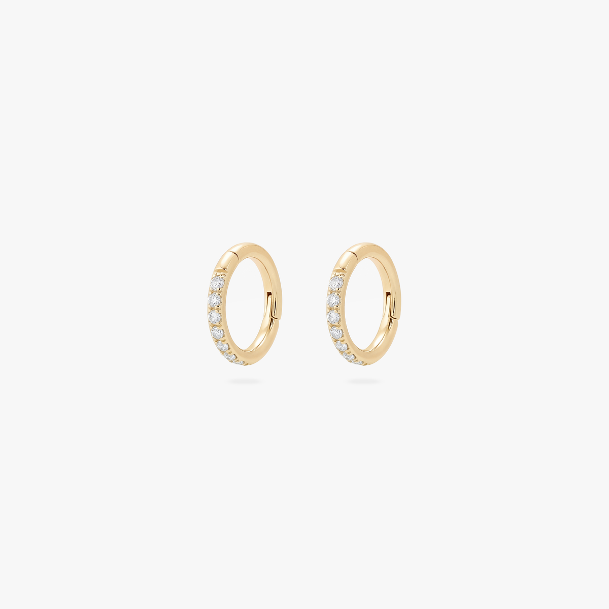 Pair of 5mm gold pave clickers on a white background