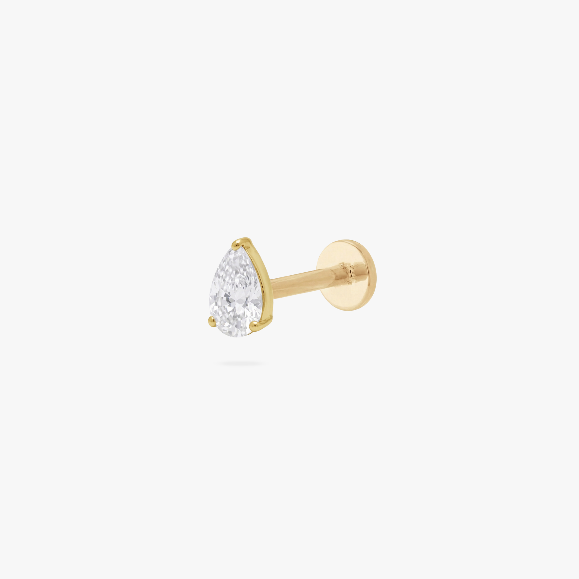 This is an image of a gold toned flatback stud with a 5mm clear, pear cut CZ . - Main view