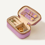 Pink jewelry box with full of earrings in various compartments