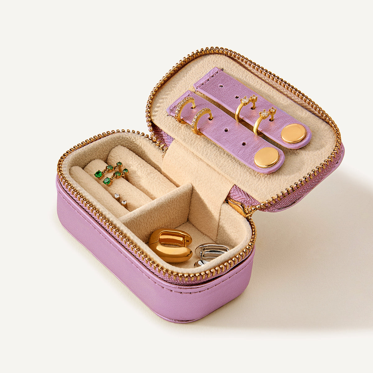 Pink jewelry box with full of earrings in various compartments