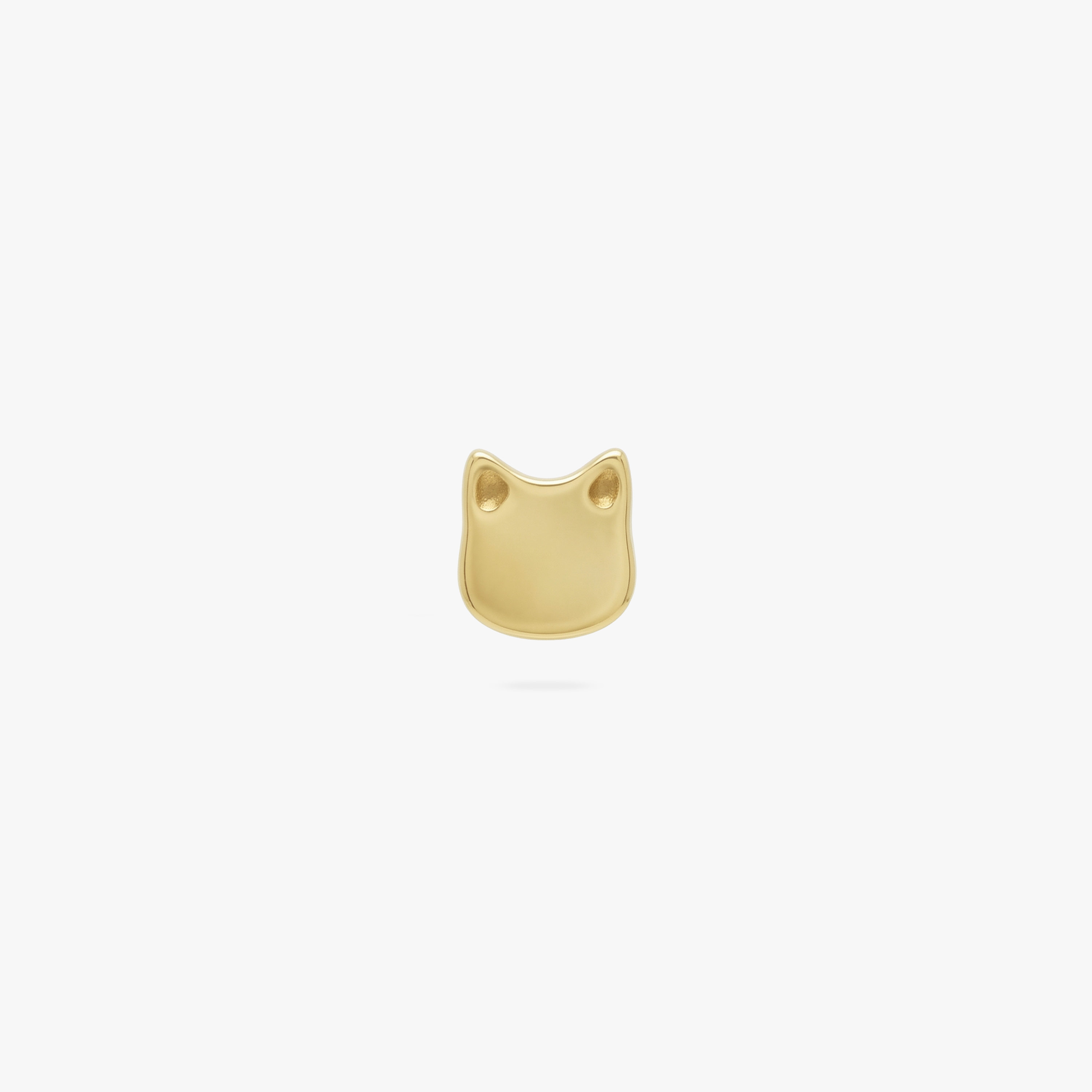 This is an image of a golden flatback stud shaped like a cat's head.