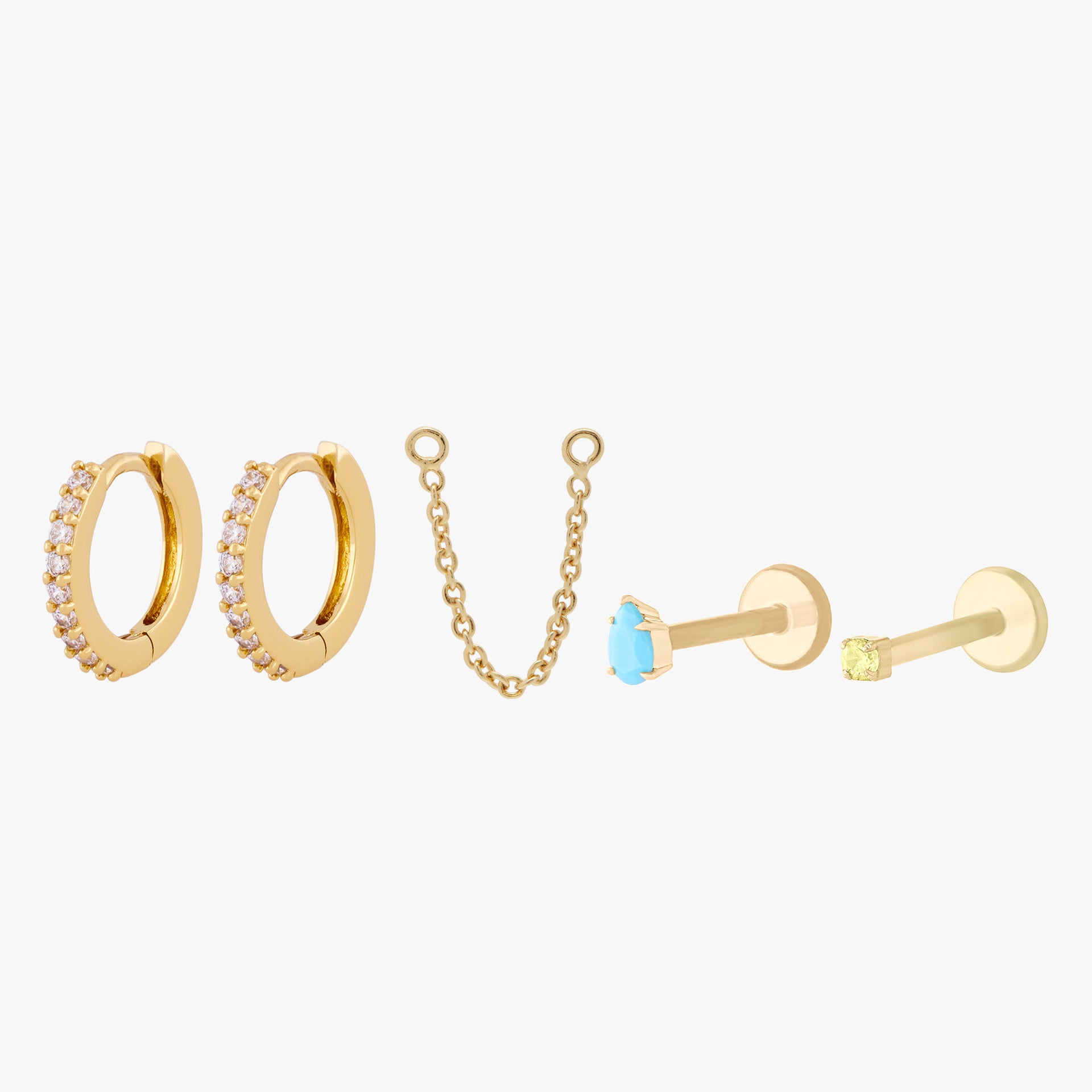 This image shows a set of two pave huggies with a connector chain, a 14k yellow gold Pear flatback with a cz aquamarine stone and a 14k Gold plated micro cz flatback stud with a topaz cz stone.