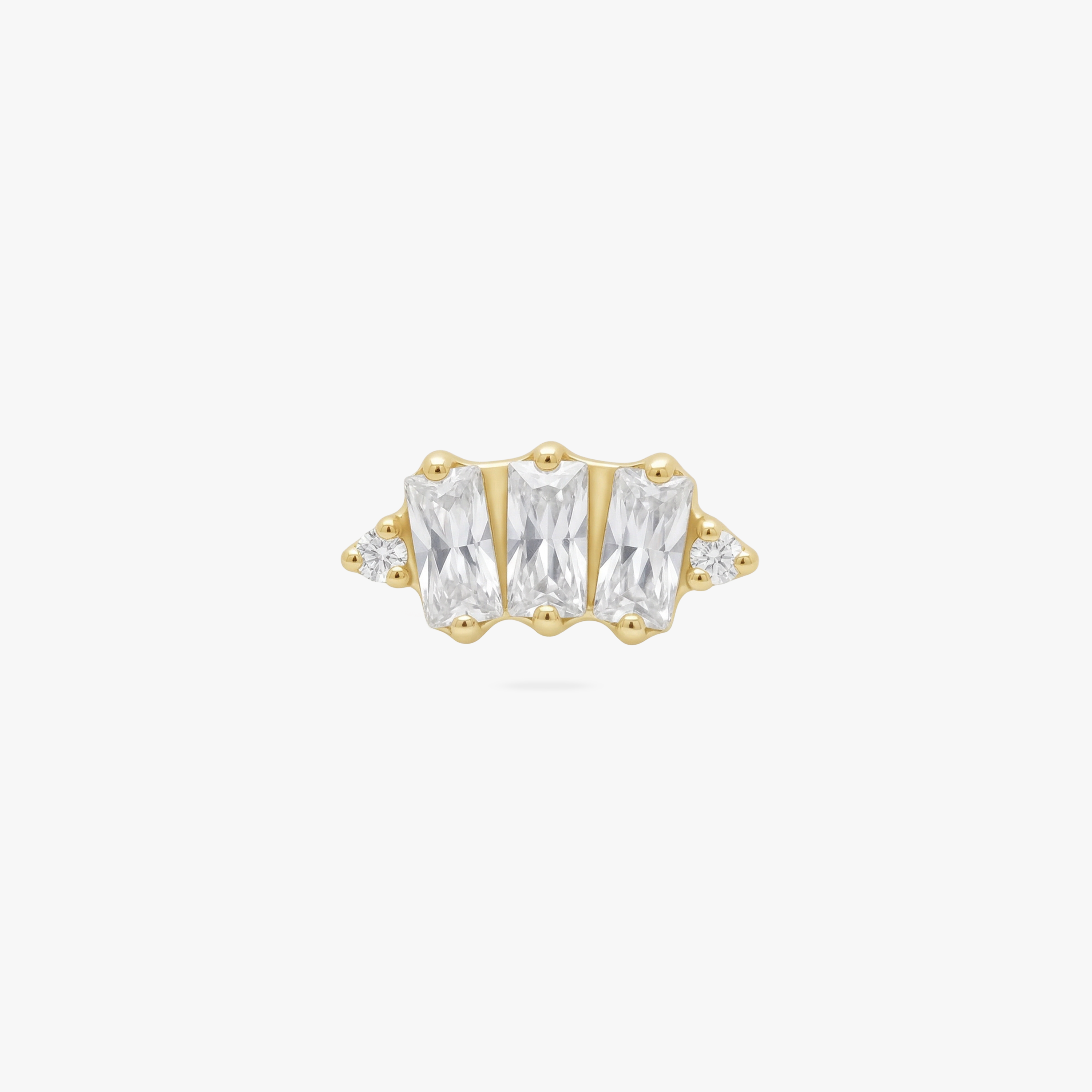 This is an image of a gold toned flatback stud which displays three clear, baguette cut CZ stones in a crown shape with two round, clear CZ stones on both ends of the crown. 
