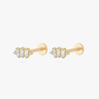 This is an image of a pair of gold toned flatback studs which display three clear, baguette cut CZ stones in a crown shape with two round, clear CZ stones on both ends of the crown. 