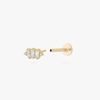 This is an image of a gold toned flatback stud which displays three clear, baguette cut CZ stones in a crown shape with two round, clear CZ stones on both ends of the crown. 