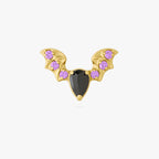 This image shows the front view of the golden titanium bat flatback with a center black cz stone and purple mini cz stones on the wings 