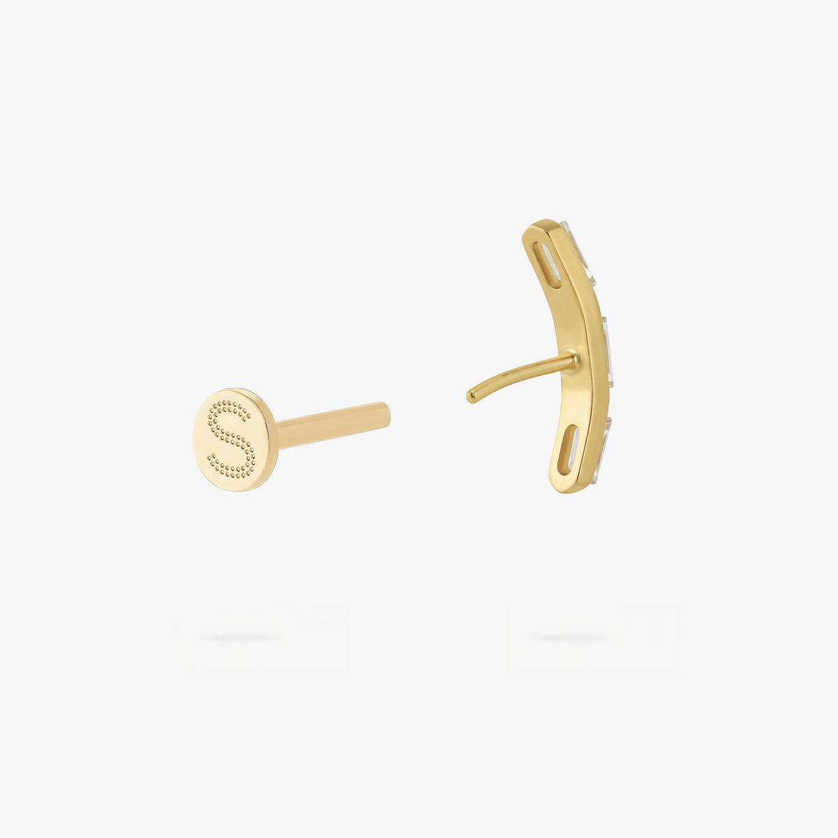 This is an image of a gold toned flatback stud that is in the shape of a curved bar and consists of three baguette cut, clear CZ stones.