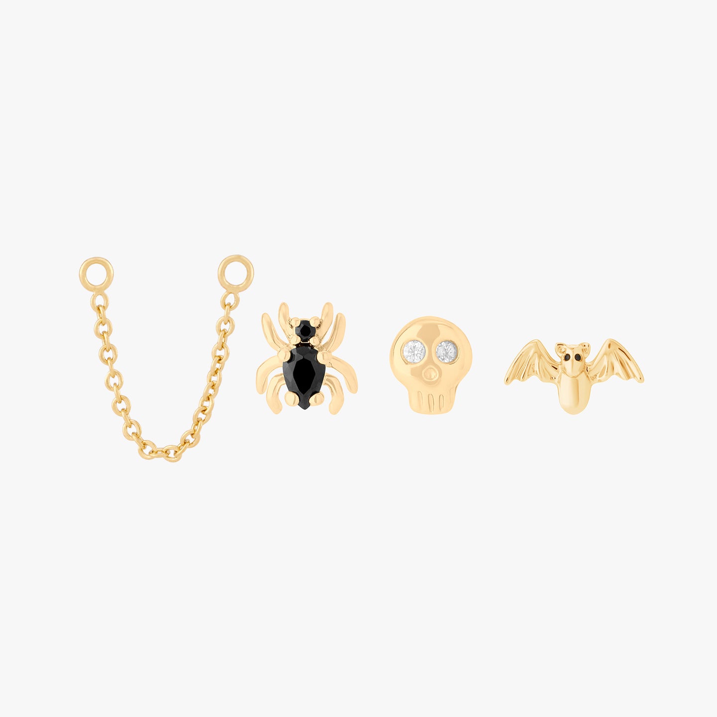 spooky set featuring a connector chain, bat stud, skull stud, and spider stud in gold color:null|gold