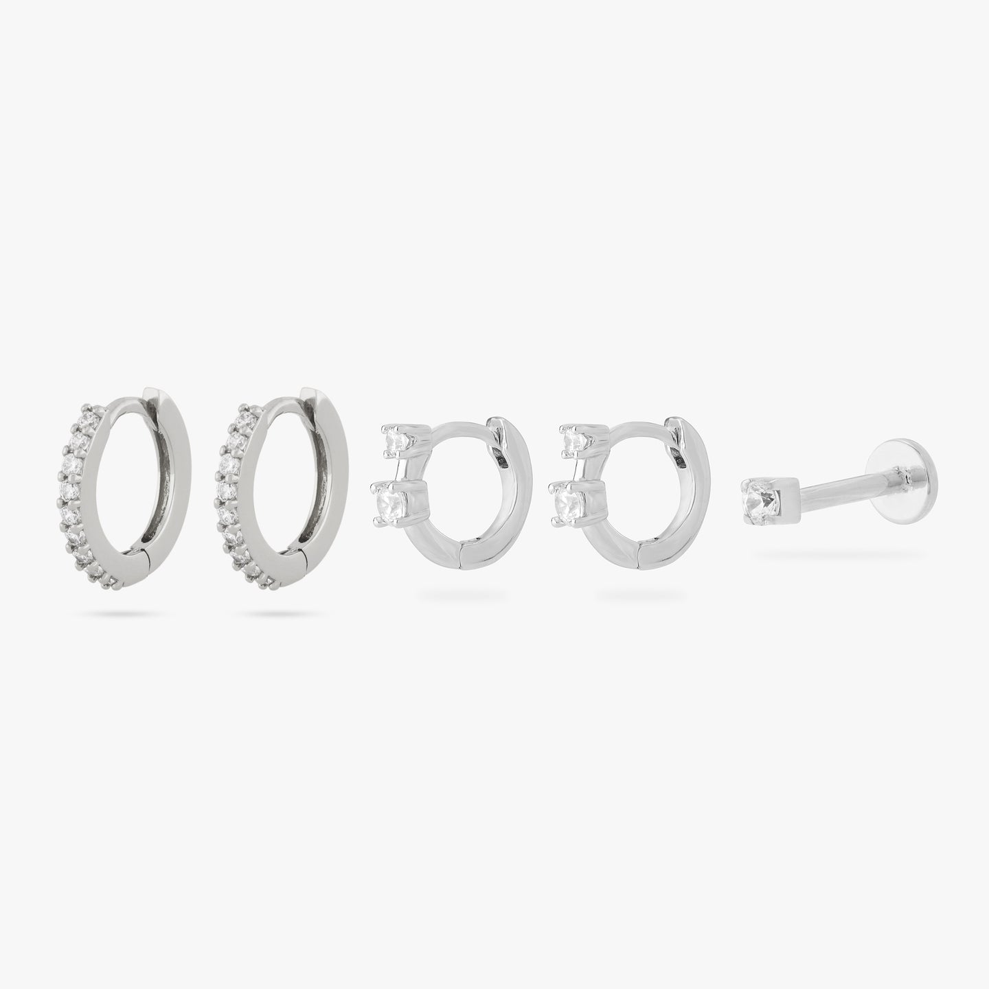 set including a pair of mini pave huggies, a pair of micro duo cz huggies, and a mini cz flatback stud in silver color:null|silver/clear