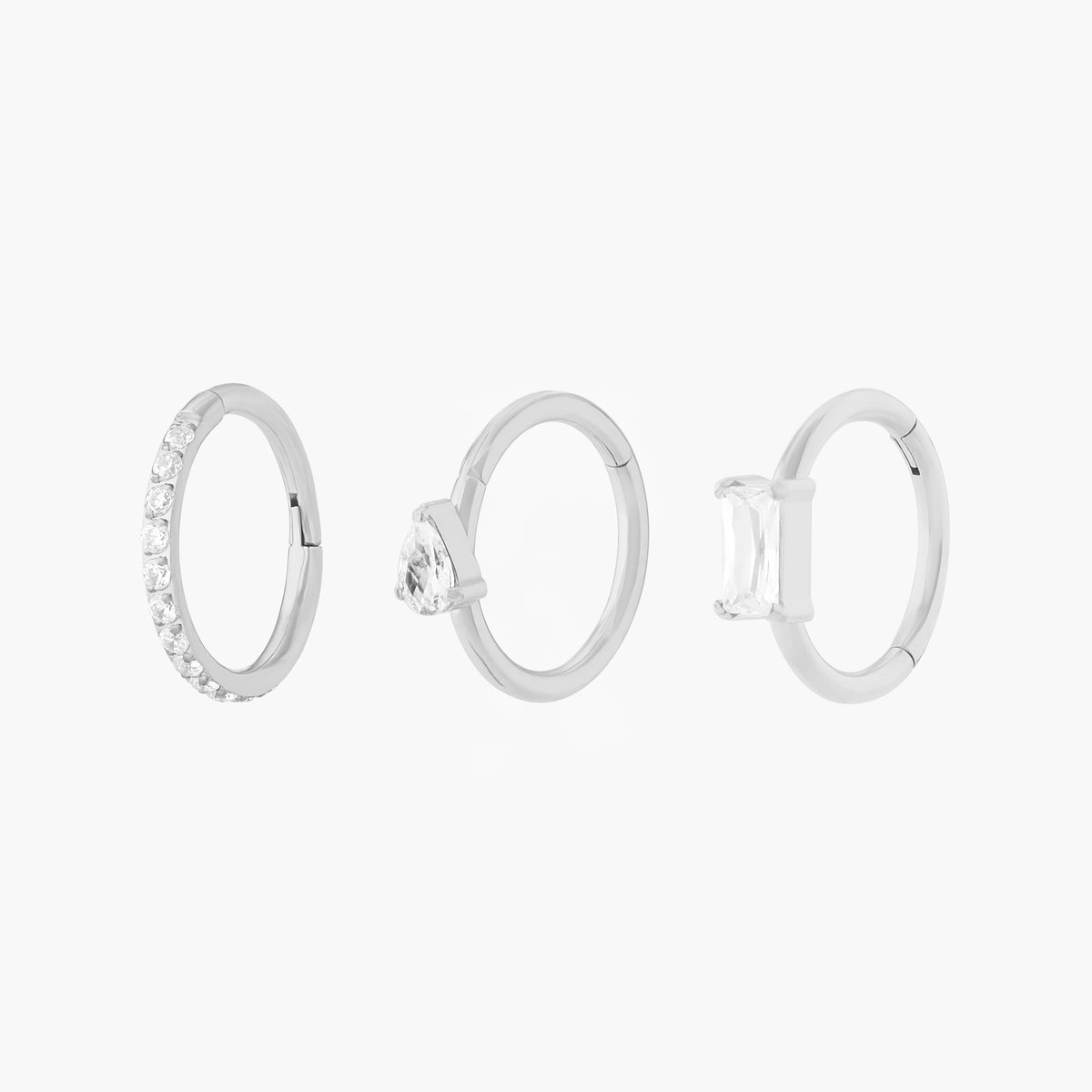 This Sparkle Clicker Set includes a Pave Clicker, Pear CZ Clicker, and Baguette Clicker. These clickers are all silver-toned with clear CZ stone accents, and they are all 8mm in diameter.