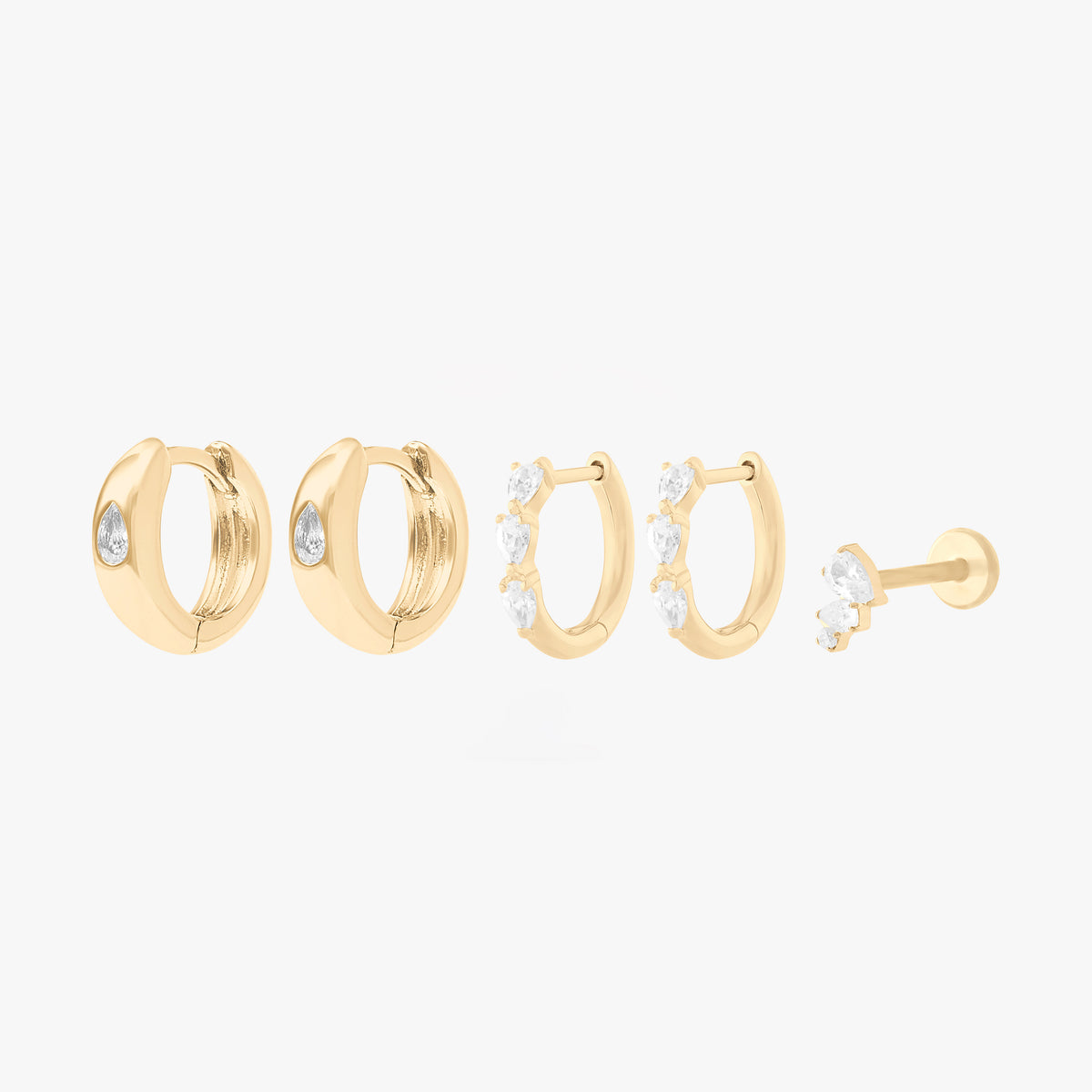 This Pear Starter Set includes 2 mini pave pear huggies, 2 chunky pear cz huggies, and one pear cluster flatback stud. These styles are all gold-toned with clear CZ stone accents.