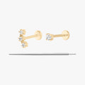 This image displays a set of two 14K gold flatback studs and a flatback insertion tool. The two earrings included in this set are the 14K Mini CZ Flatback Stud in gold/cleat, as well as the 14K Cluster Flatback Stud in gold/clear.