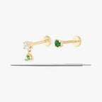 This image displays a set of two 14K gold flatback studs and a flatback insertion tool. The two earrings included in this set are the 14K Mini CZ Flatback Stud in gold/green, as well as the 14K CZ Dangle Flatback Stud in gold/green. 