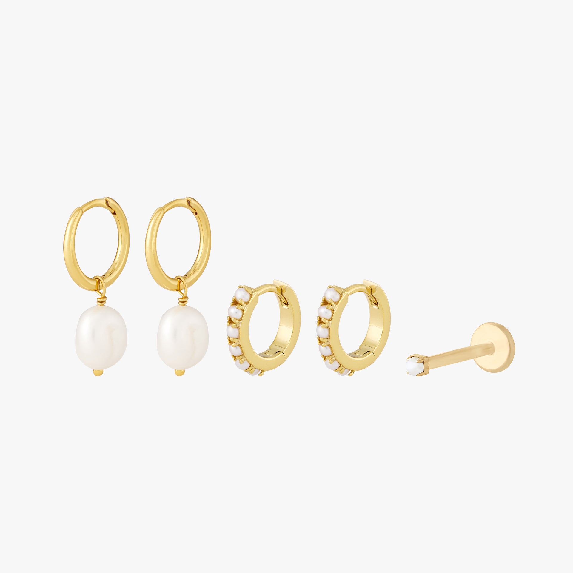 This Pearl Starter Set includes 2 baroque pearl huggies, 2 pearl huggies, and one micro pearl flatback stud. These styles are all gold toned with pearl accents. - Main view