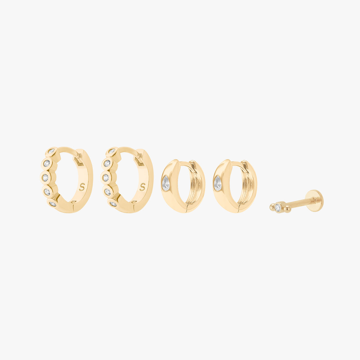 Set of gold hoop earrings with 2 pairs of bezel huggies and a micro bezel flatback