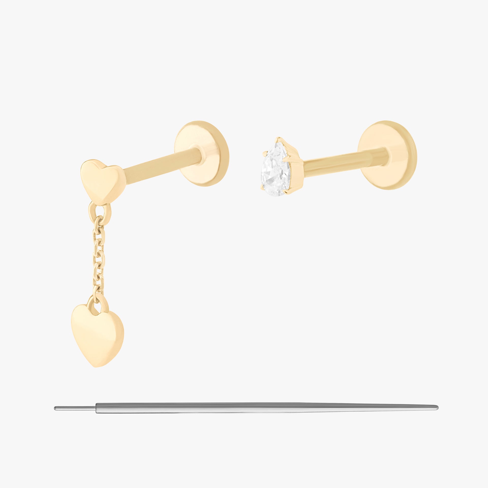 This is an image displaying the 14K Pear(fect) Pair Set. This includes a 14K Double Heart Dangle Flatback Stud as well as a 14K Pear CZ Flatback Stud and an insertion tool.