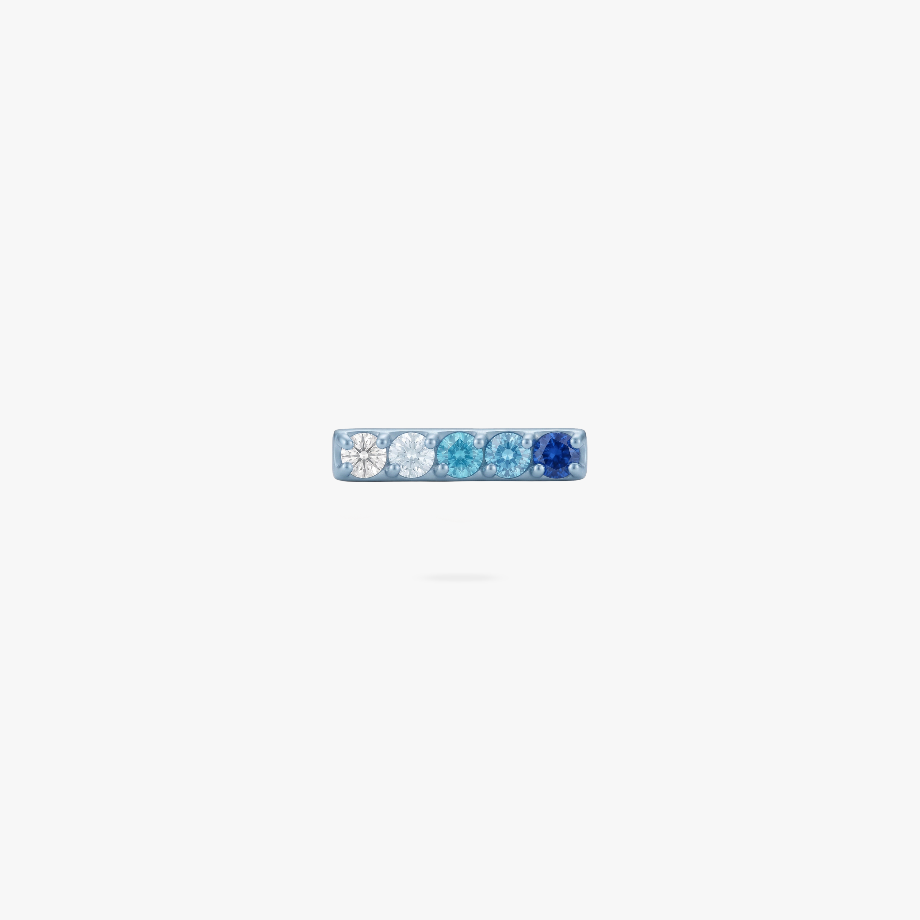 This is an image of an anodized blue flatback stud with a gradient of 5 blue CZ stones creating a pave bar. 