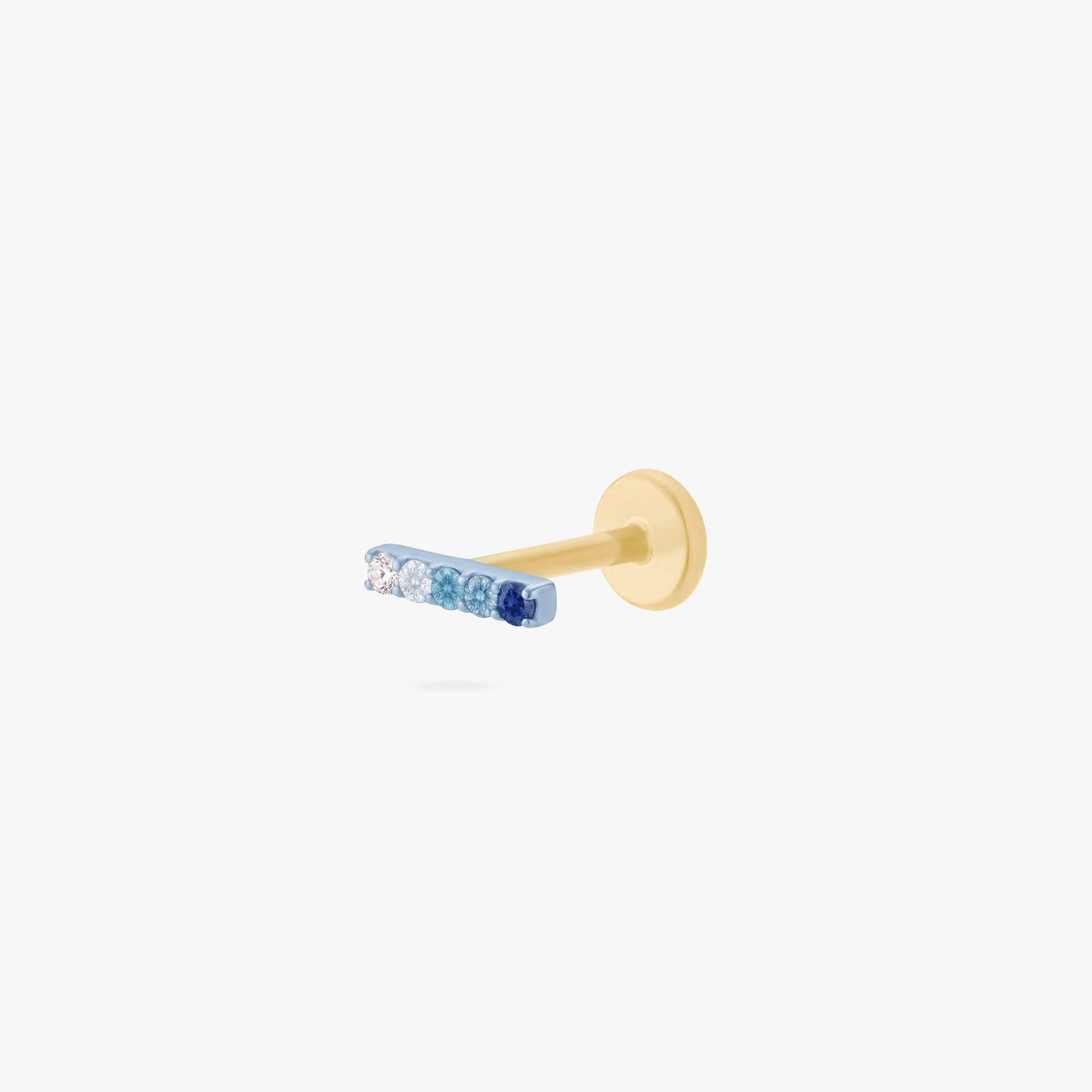 This is an image of an anodized blue flatback stud with a gradient of 5 blue CZ stones creating a pave bar. The flatback post for this earring is gold toned. - Main view
