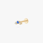 this image shows a side view of a gold plated flatback with one blue cz stone in the middle and two clear cz stones on the sides. 