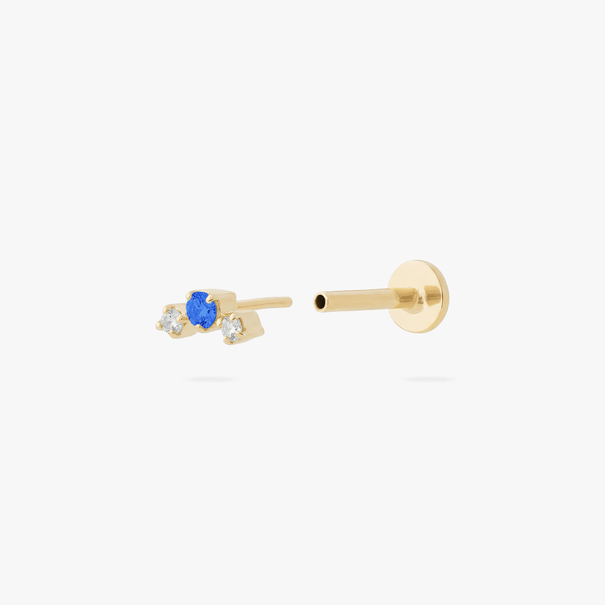 this image shows a gold plated micro cluster flatback with two clear and one blue cz stones