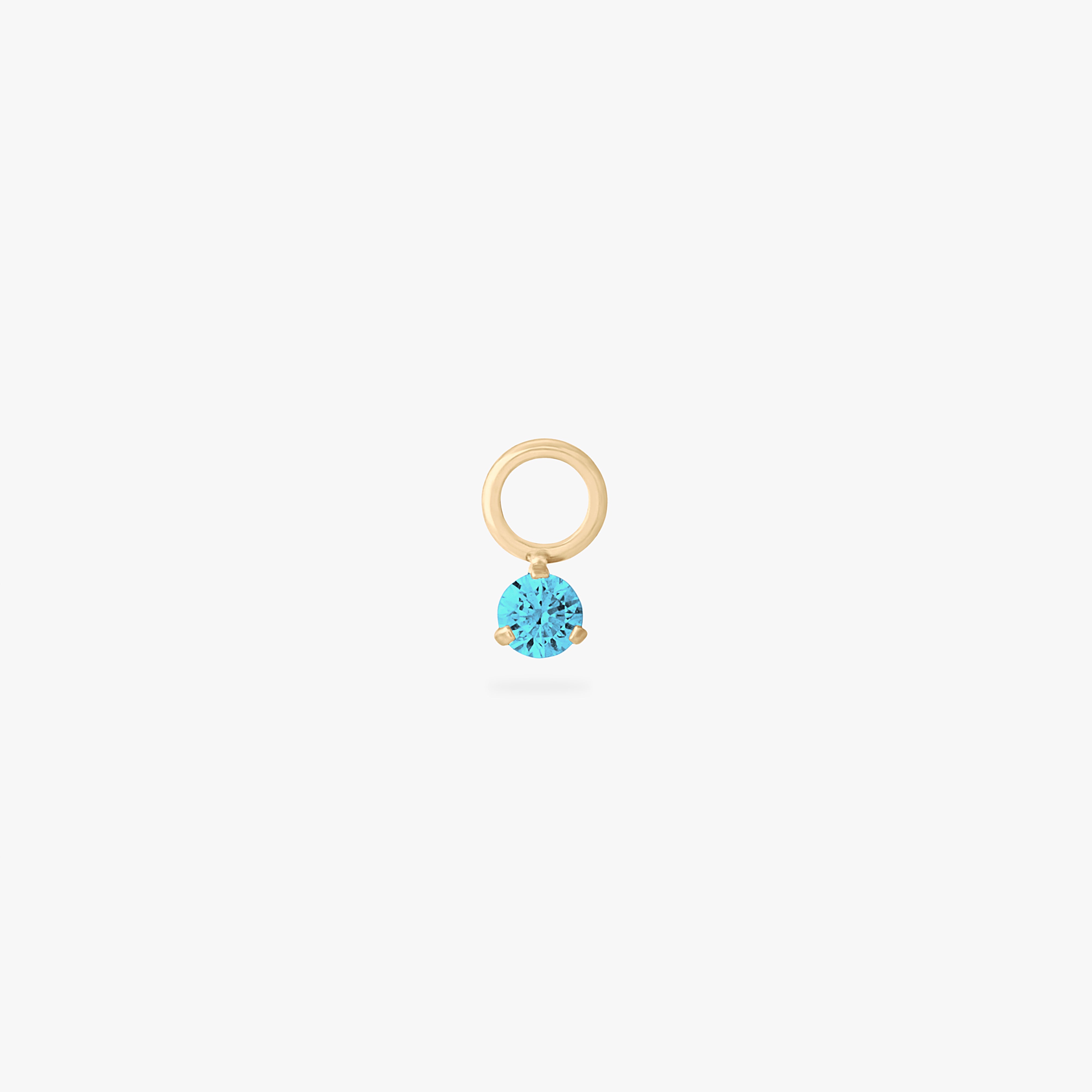 This is an image of a gold charm for a clicker that has a micro aquamarine cz on it. color:null|aquamarine
