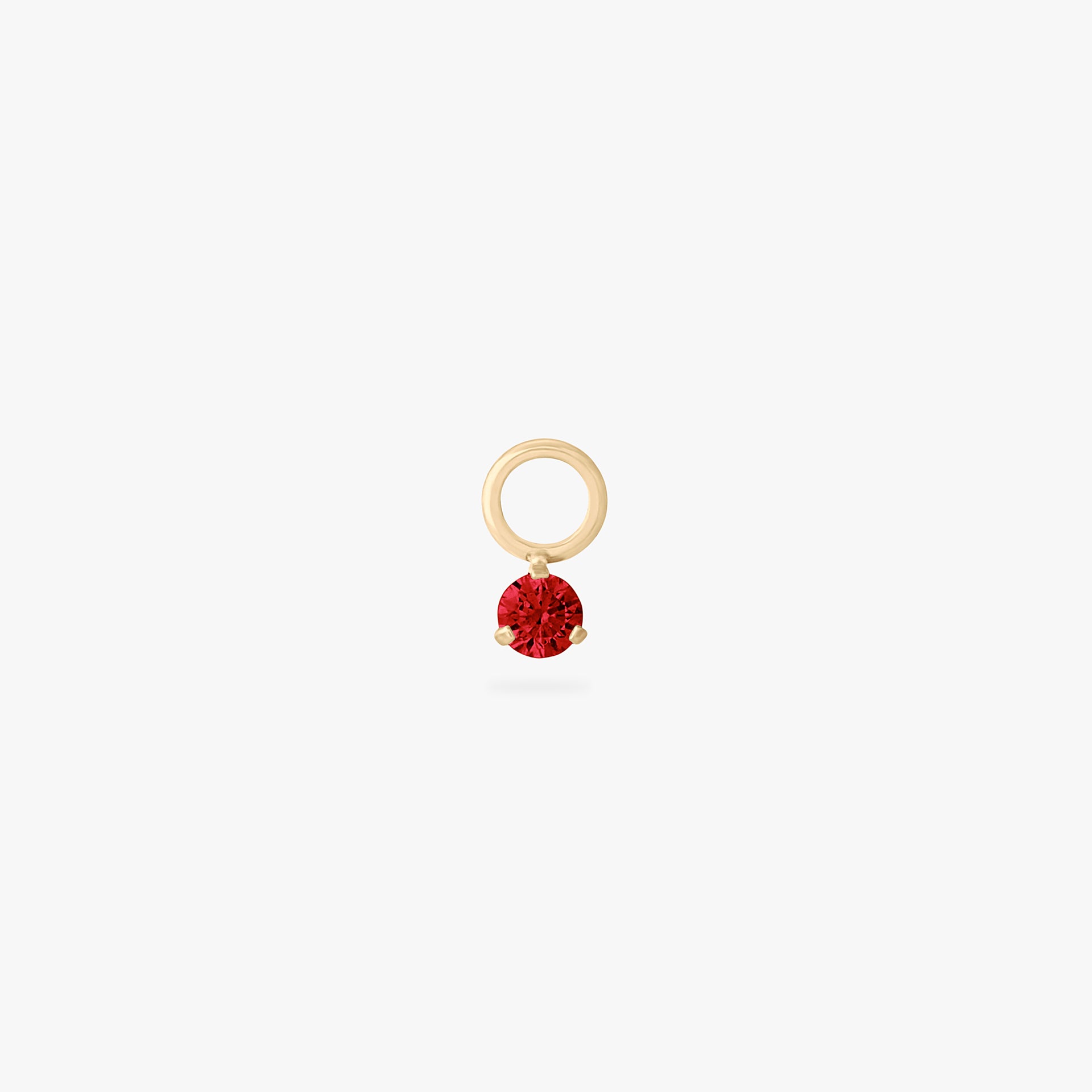 This is an image of a gold charm for a clicker that has a micro garnet cz on it. color:null|garnet