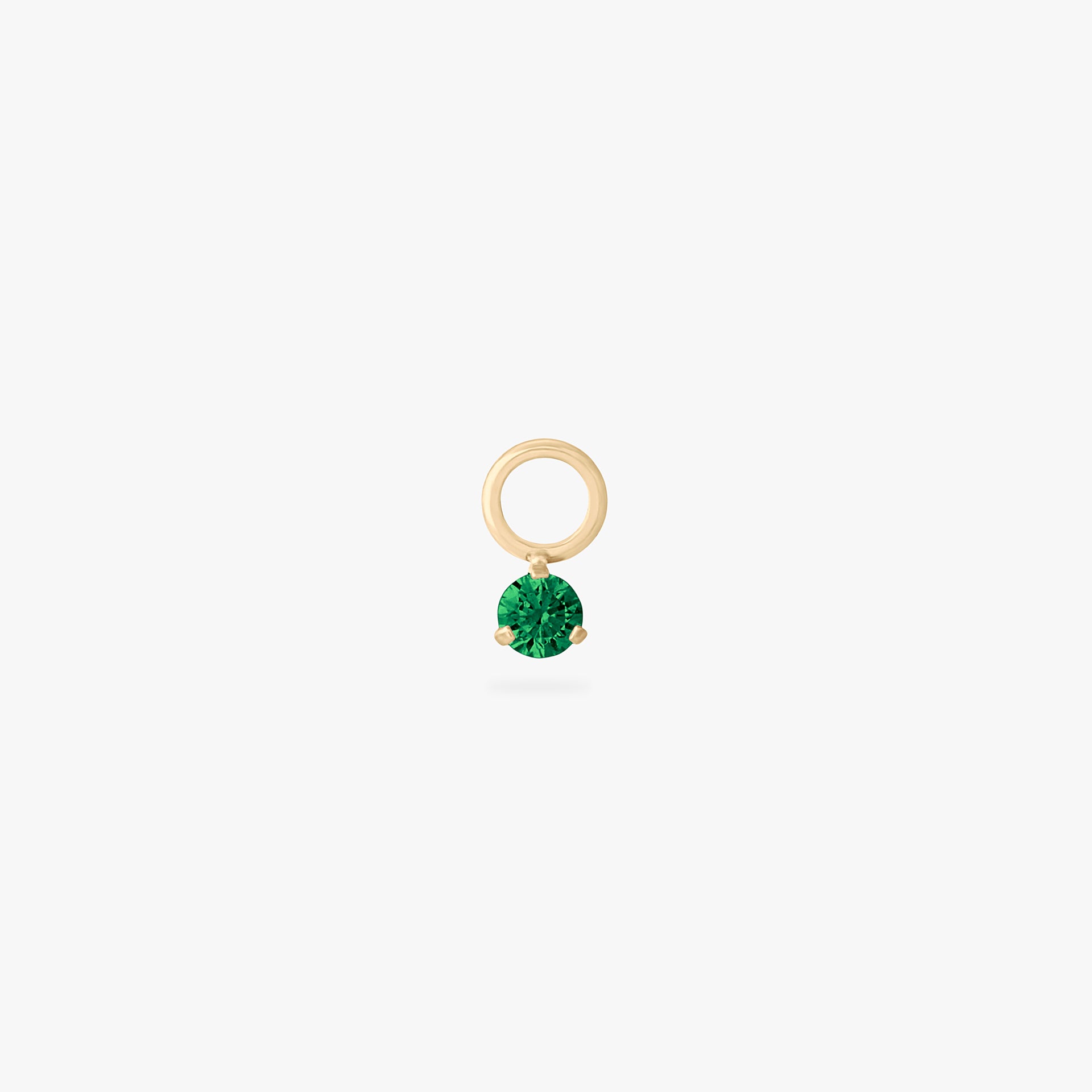 This is an image of a gold charm for a clicker that has a micro emerald cz on it. color:null|emerald