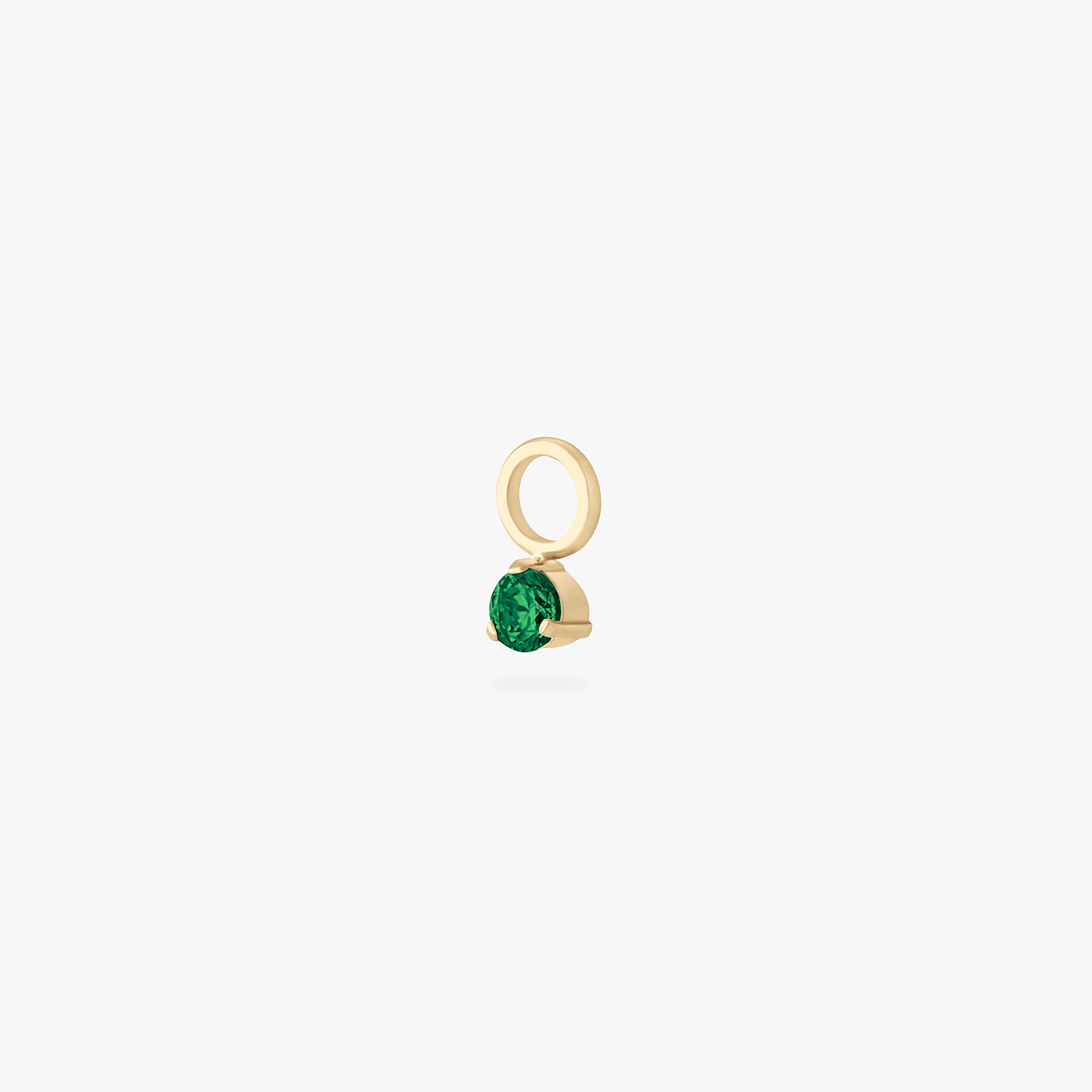 This is an image of a gold charm for a clicker that has a micro emerald cz on it. color:null|emerald