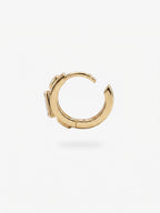 This image shows the profile view of a 14k gold plated huggie with three cz stones. One green square in the middle and two clear circular stones on the outside.