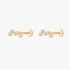 Pair of gold cluster flatback studs on a white background