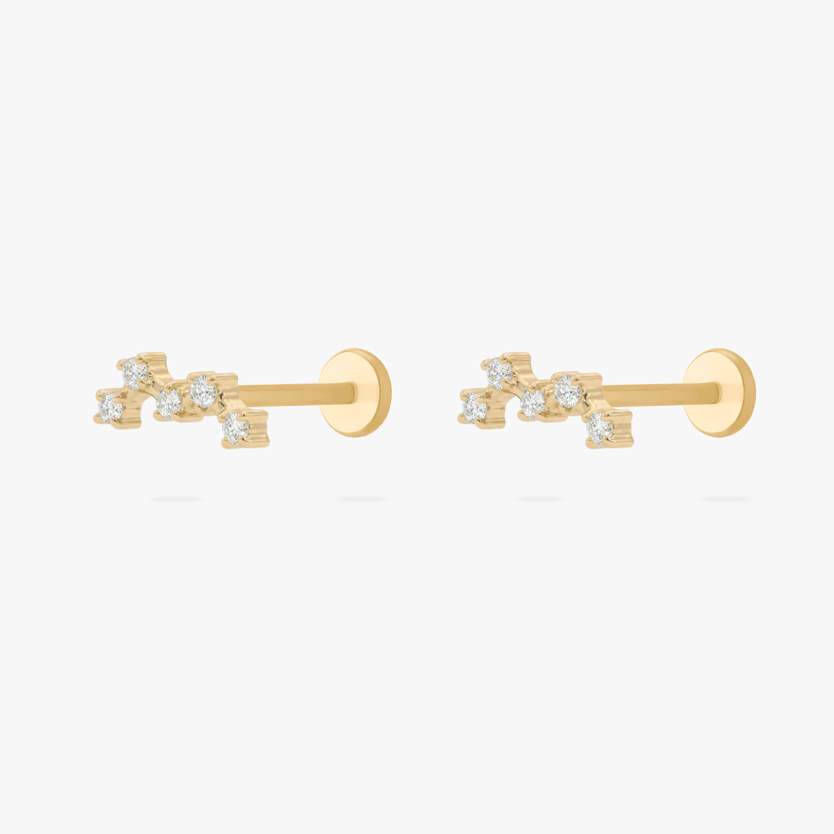Pair of gold cluster flatback studs on a white background