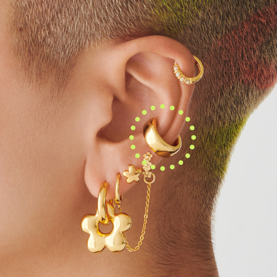 This is a gold, chunky shaped ear cuff on ear. [hover] color:null|gold