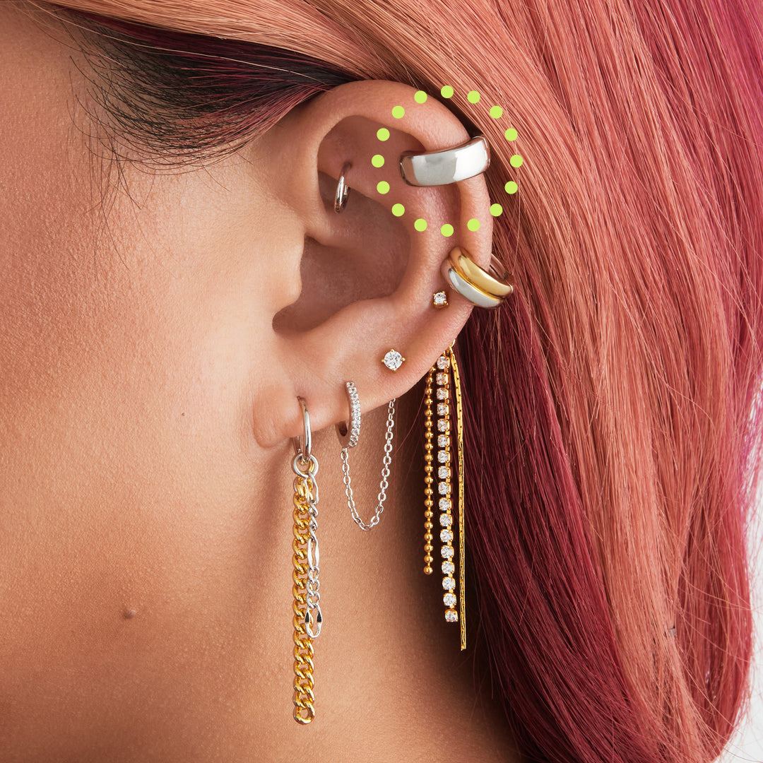 This is a silver, chunky shaped ear cuff on ear. [hover] color:null|silver