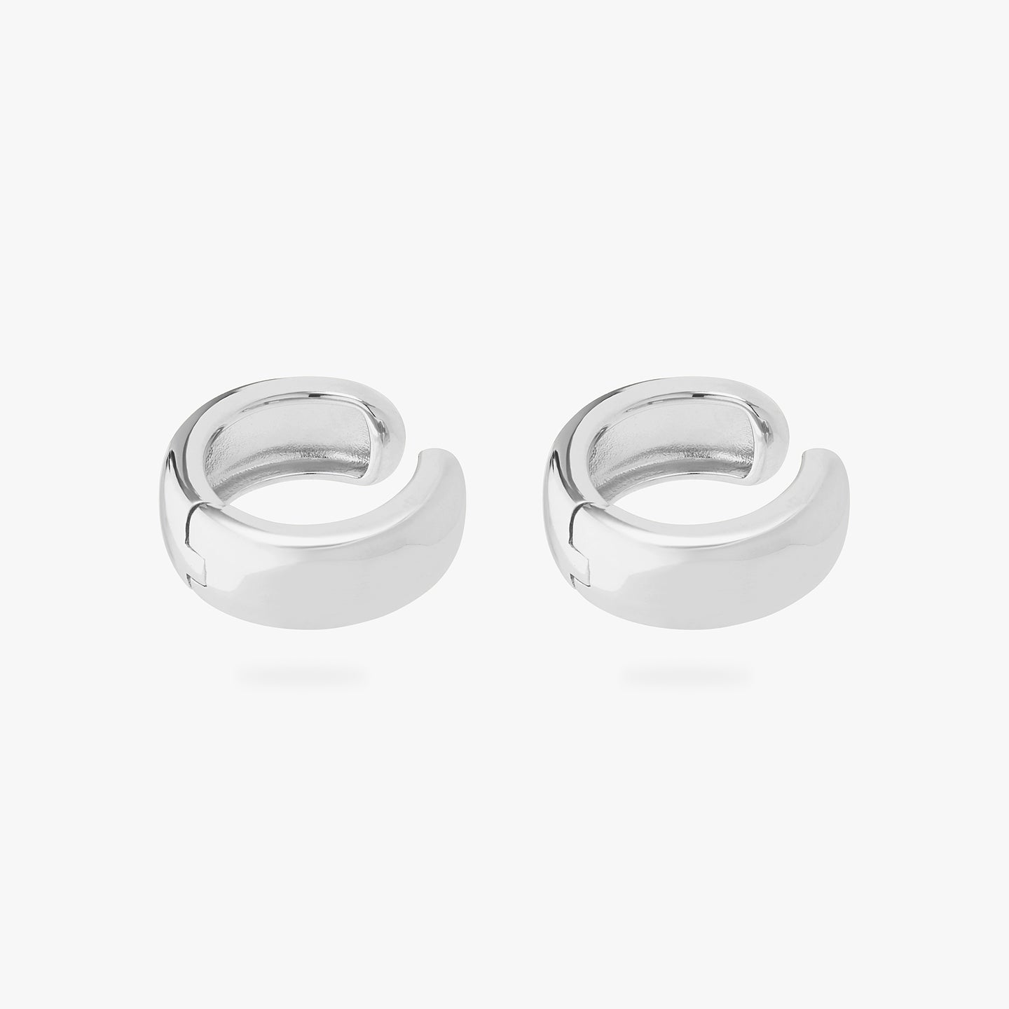 This is a pair of silver, chunky shaped ear cuffs. [pair] color:null|silver