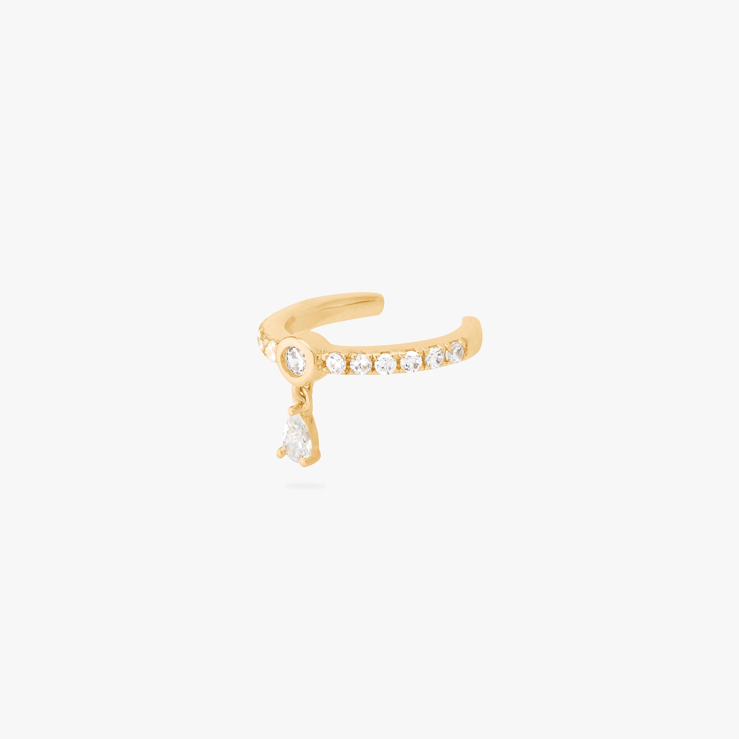 a gold/clear pave slim cuff with a bezel set clear cz stone that a second cz stone dangles from. color:null|gold/clear