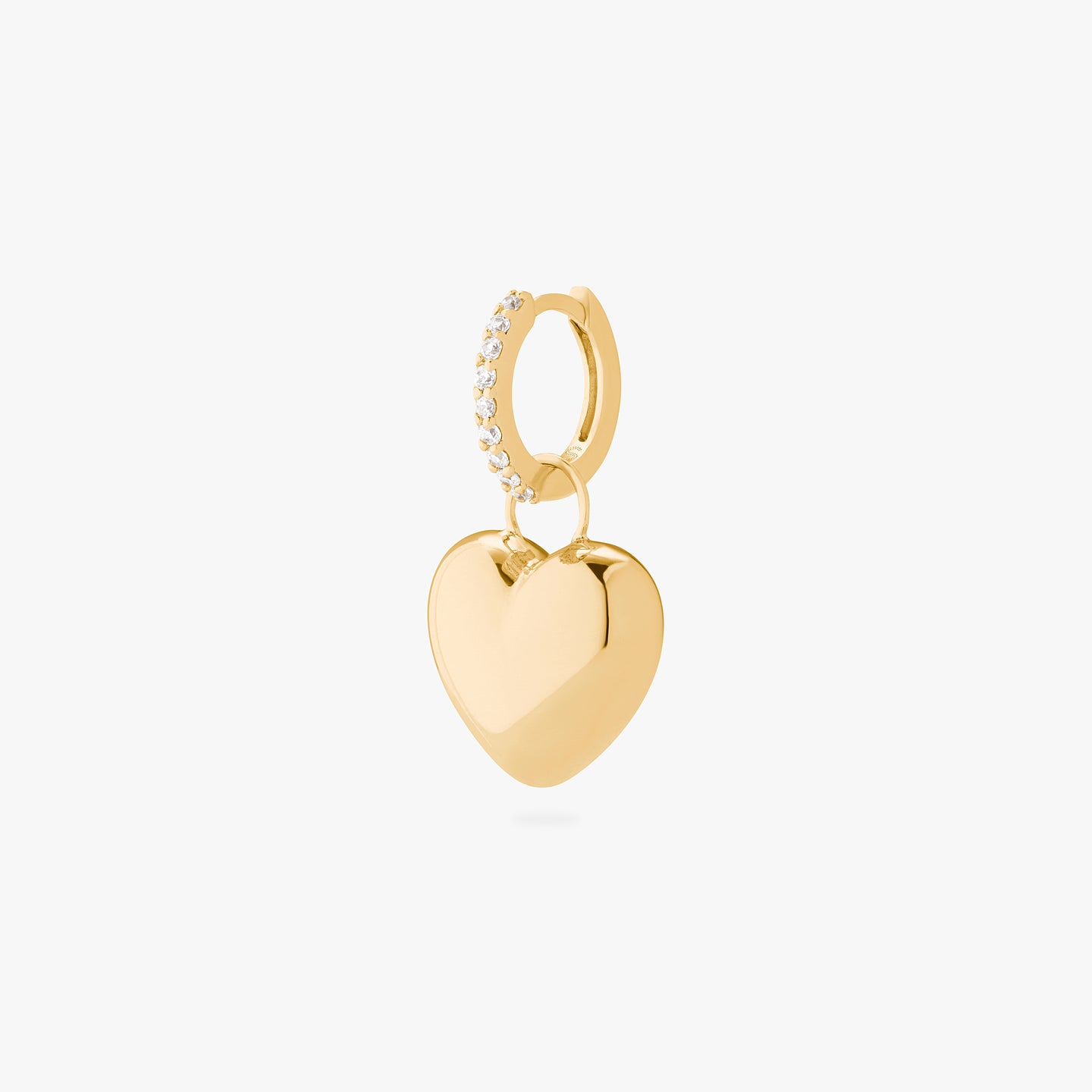 An image of a gold/clear mini pave huggie with a gold, puffy heart shaped charm. color:null|gold/clear
