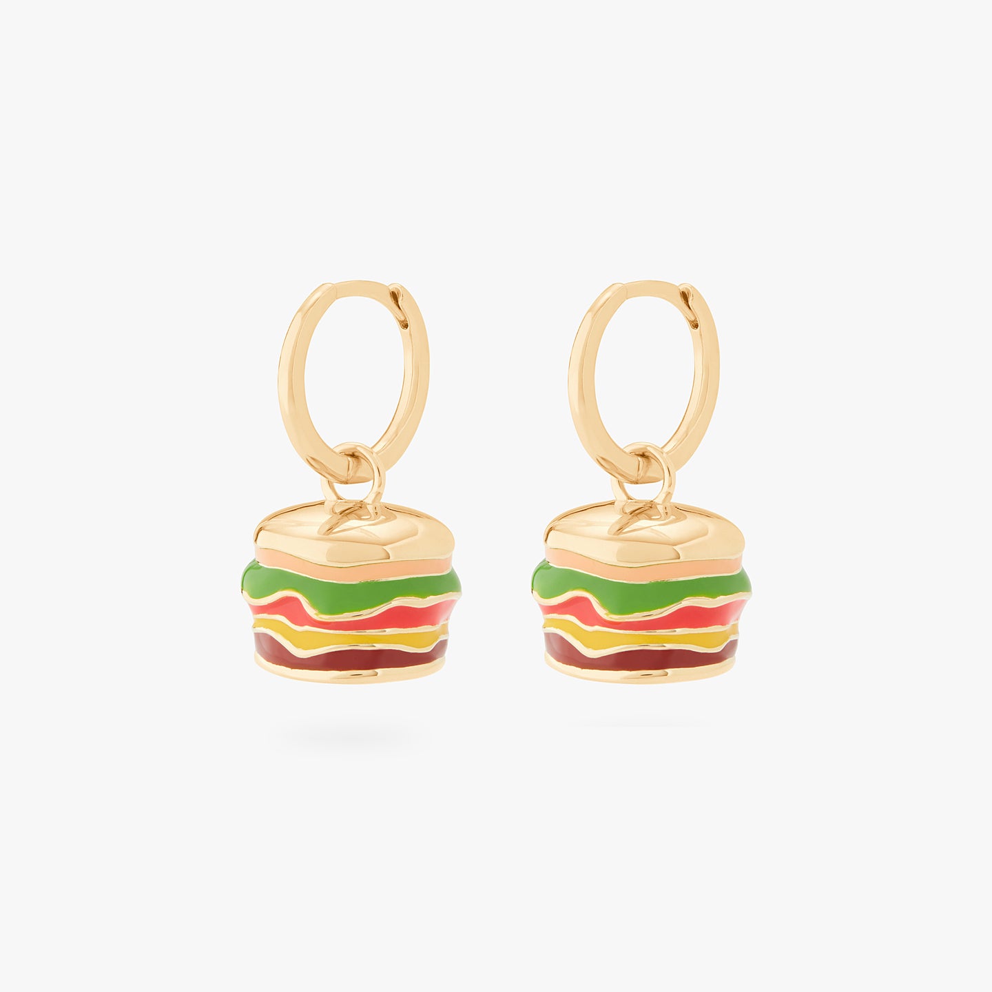 This is an image of a pair of burger-shaped, enameled charm huggies in gold created to look like Shake Shack Burgers. [pair] color:null|gold/clear