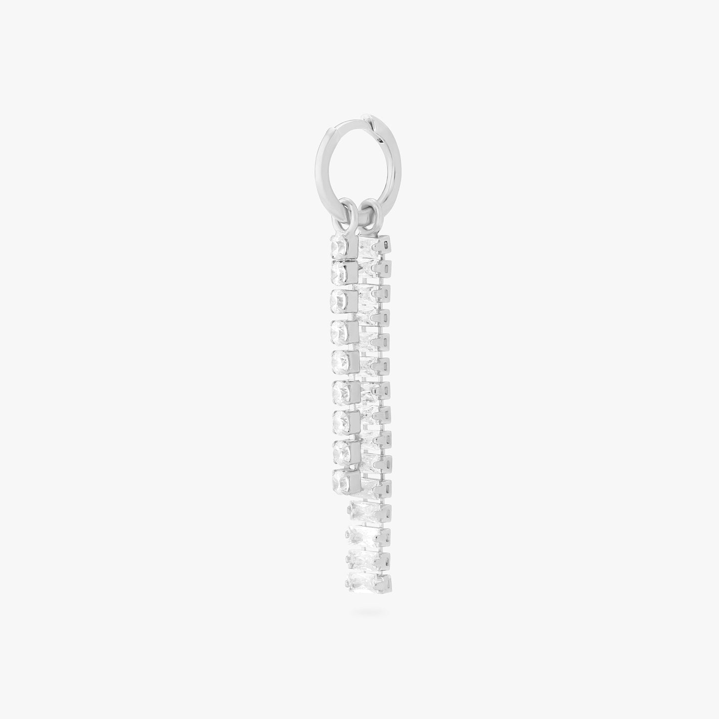 This is an image of a silver small slim huggie with a charm that consists of a string of silver/clear CZs, and a charm that consists of silver/clear baguette CZs. color:null|silver/clear