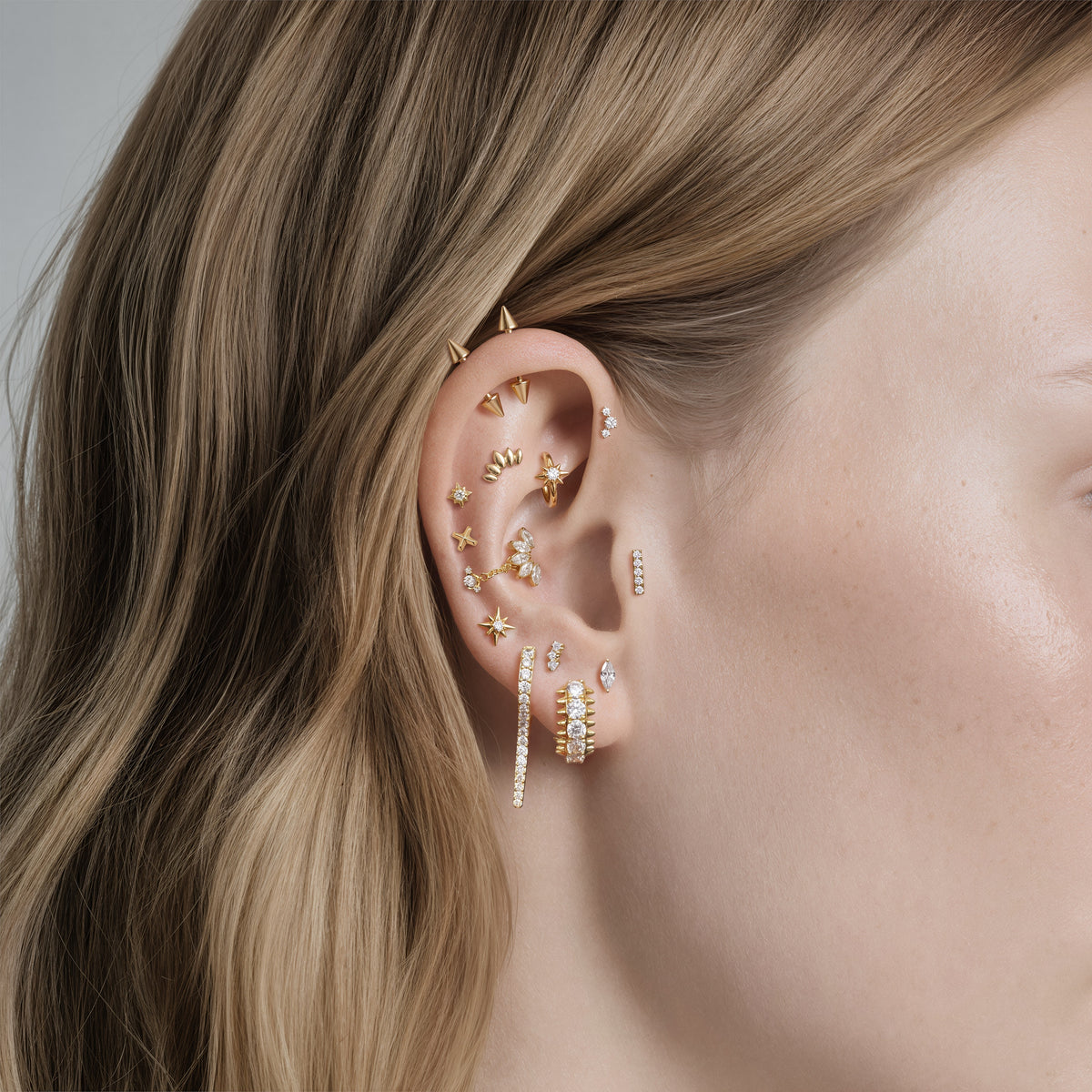 This image shows an earscape featuring the micro 14k gold x flatback 