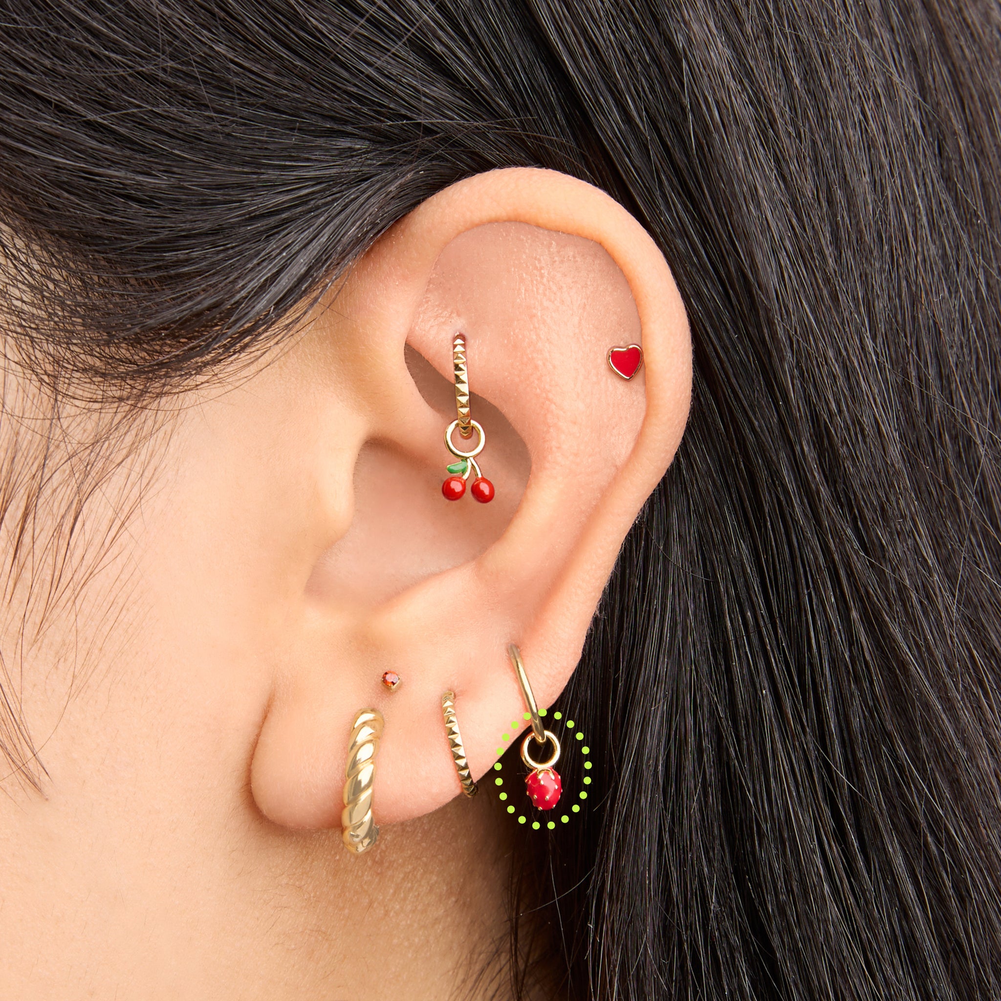 This is an image of a gold earring charm in the shape of a strawberry with red enameling on ear. [hover] color:null|gold/red