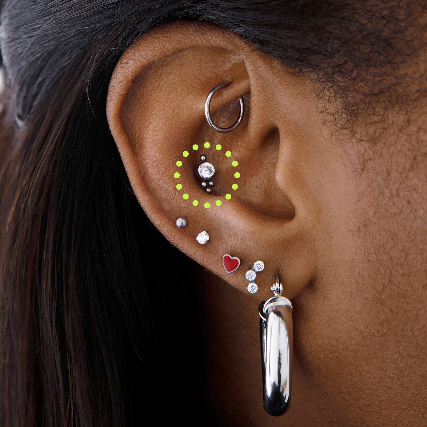 a triad shaped titanium stud with a CZ accent on ear [hover] color:null|silver/clear