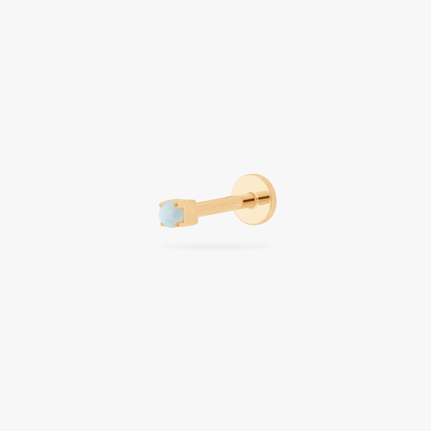 This is an image of a gold/opal flatback top with a gold labret with a circle disc and the 