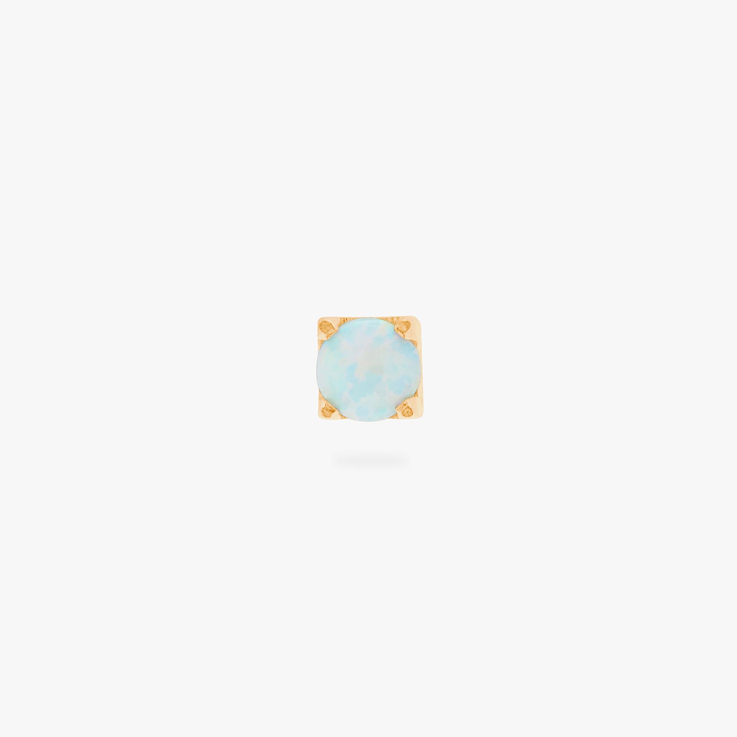 This is an image of a gold/opal flatback top with a gold labret with a circle disc and the 