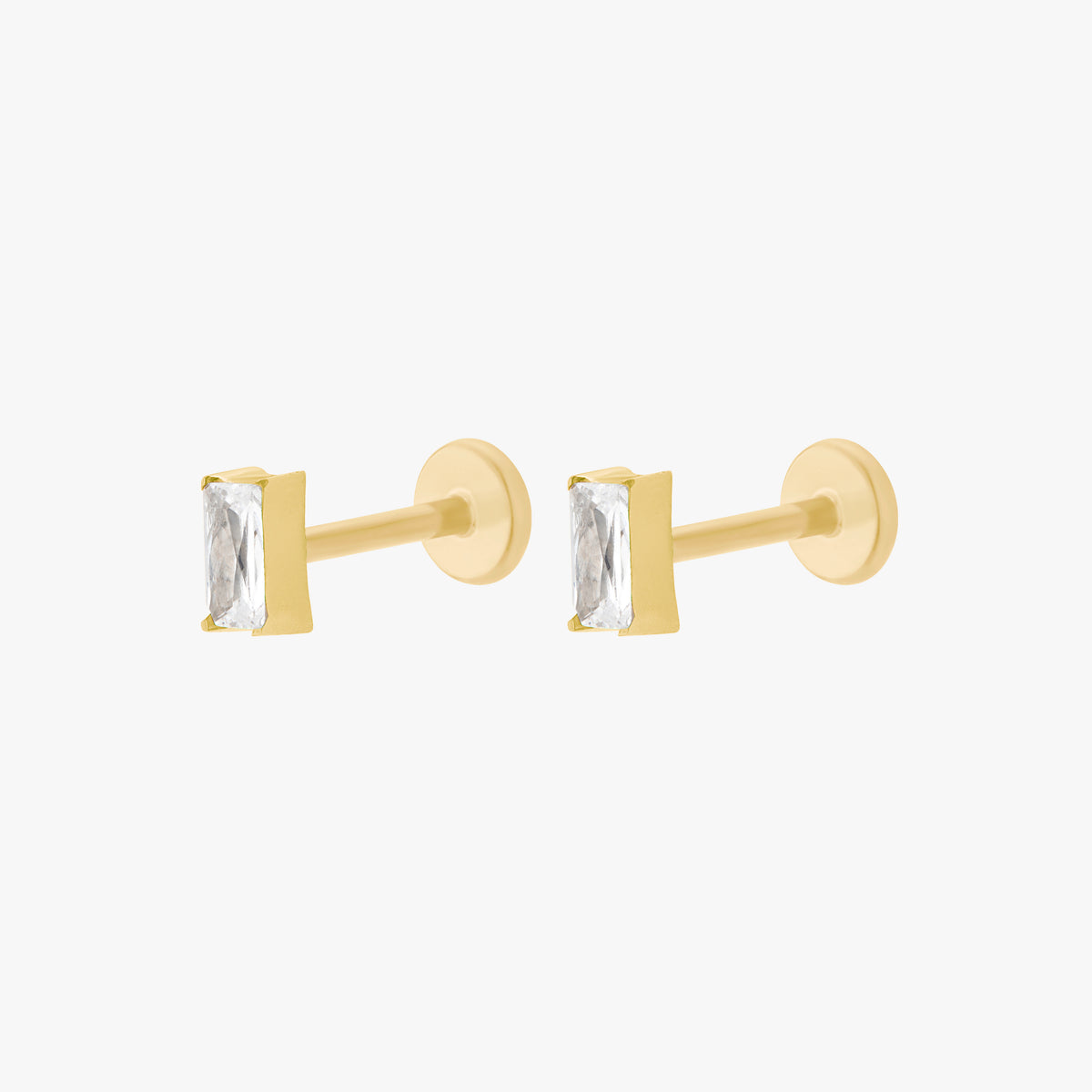 This is an image of a pair of gold toned flatback studs that display 5mm, clear baguette cut CZ stones.