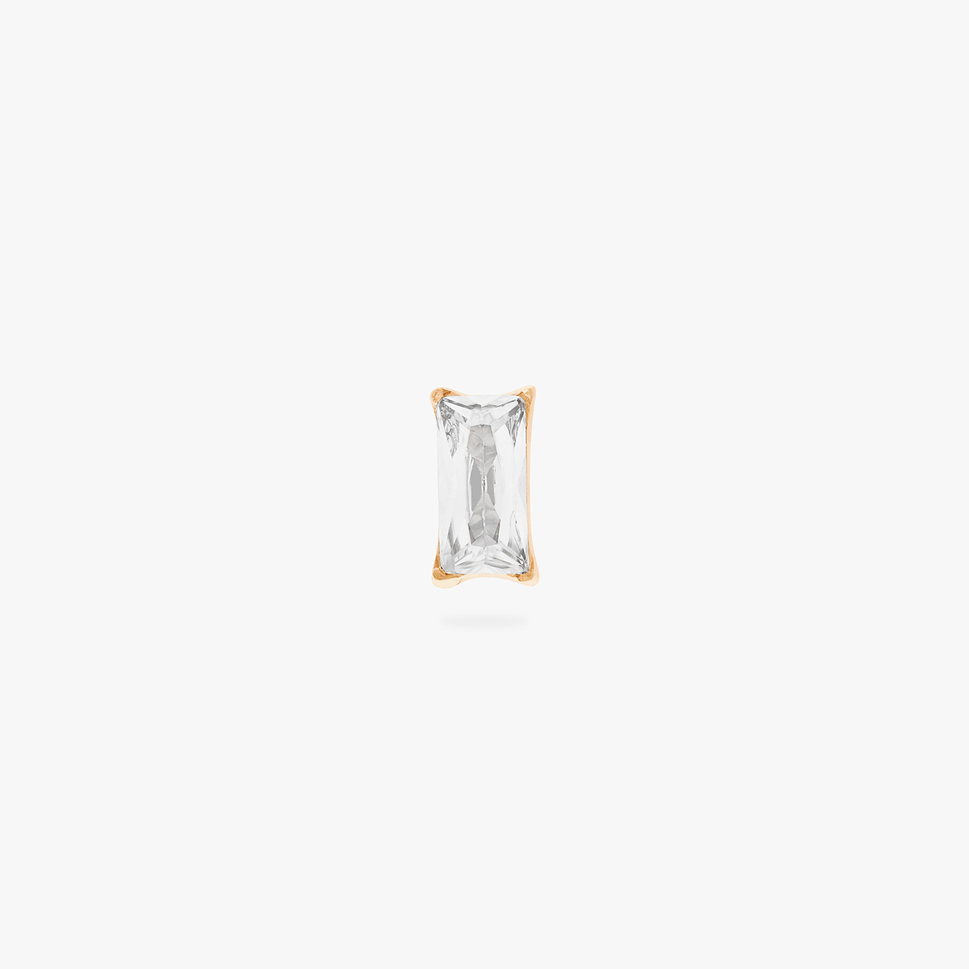 This is an image of a gold/clear baguette shaped CZ flatback stud, with a gold labret with a circle disc with an "S" logo engraved on it. color:null|gold/clear