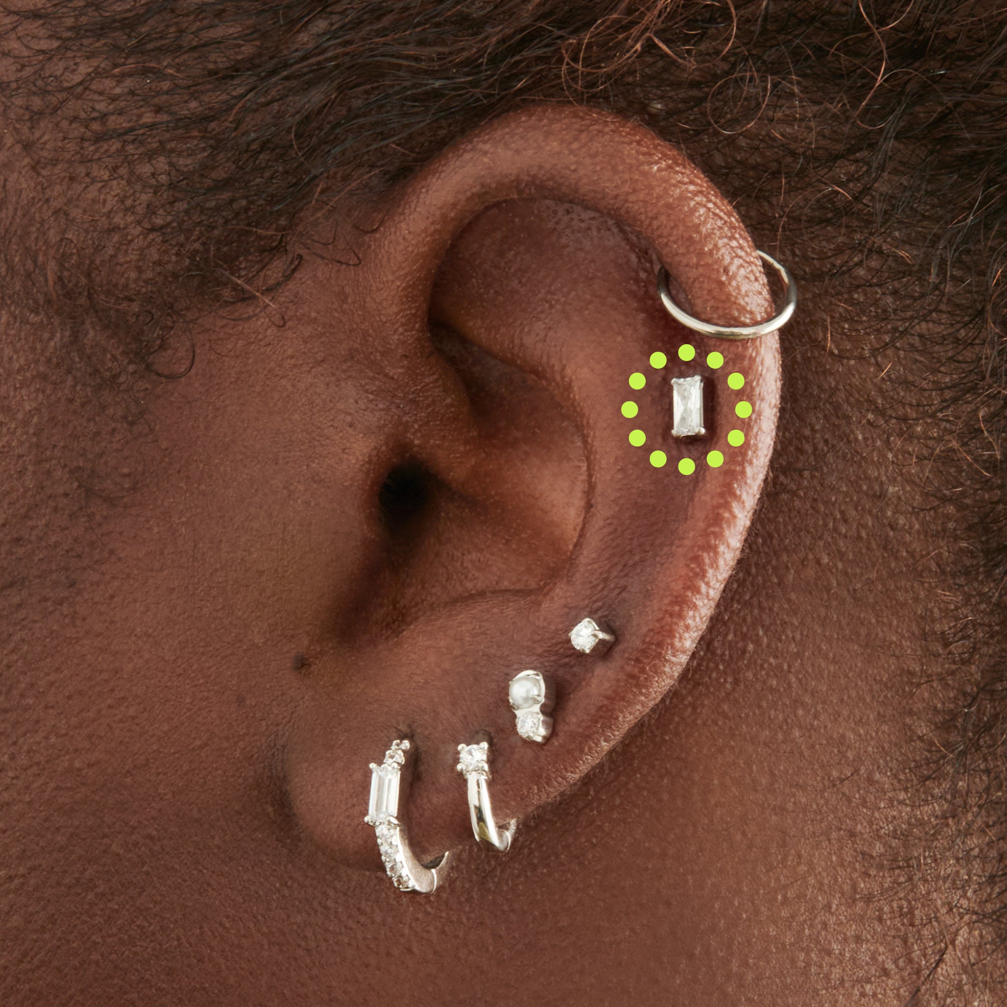 This is an image of a silver/clear baguette shaped CZ flatback stud, with a silver labret with a circle disc with an "S" logo engraved on it. [hover] color:null|silver/clear